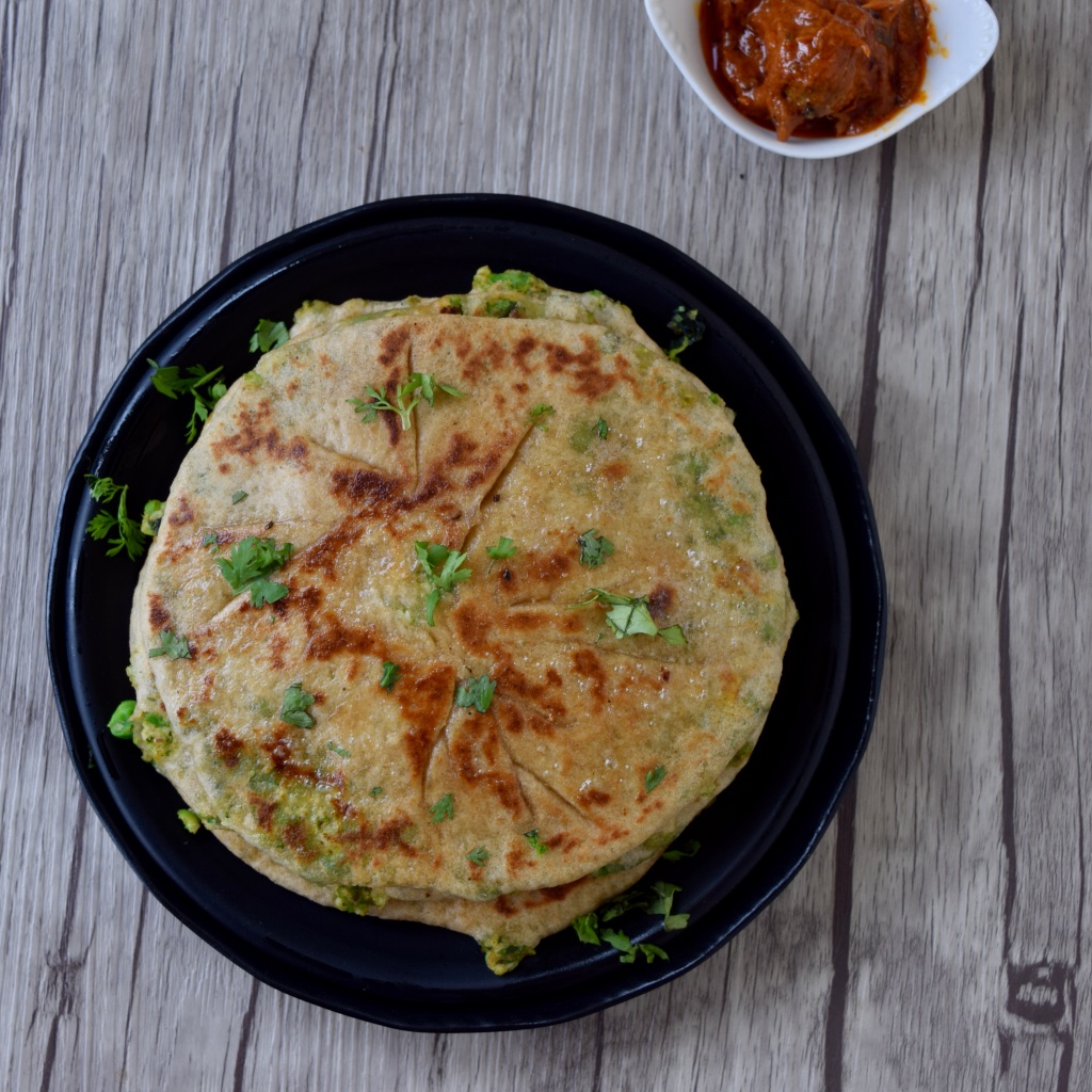 Delicious paneer peas paratha served with pickle